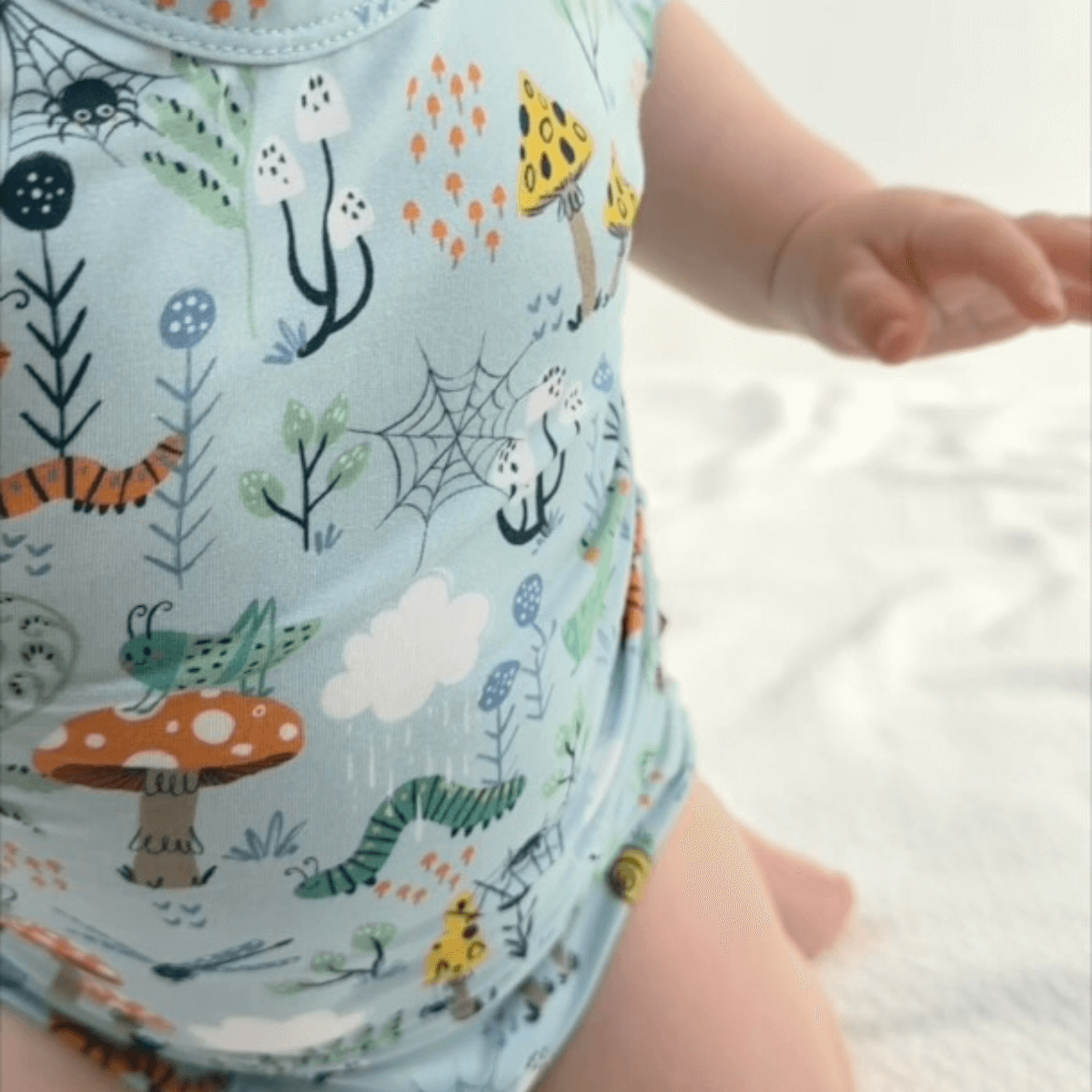 Baby wearing a cute romper featuring whimsical forest designs. 🌿 Every Purchase Makes an Impact. Pure comfort for your little one.
