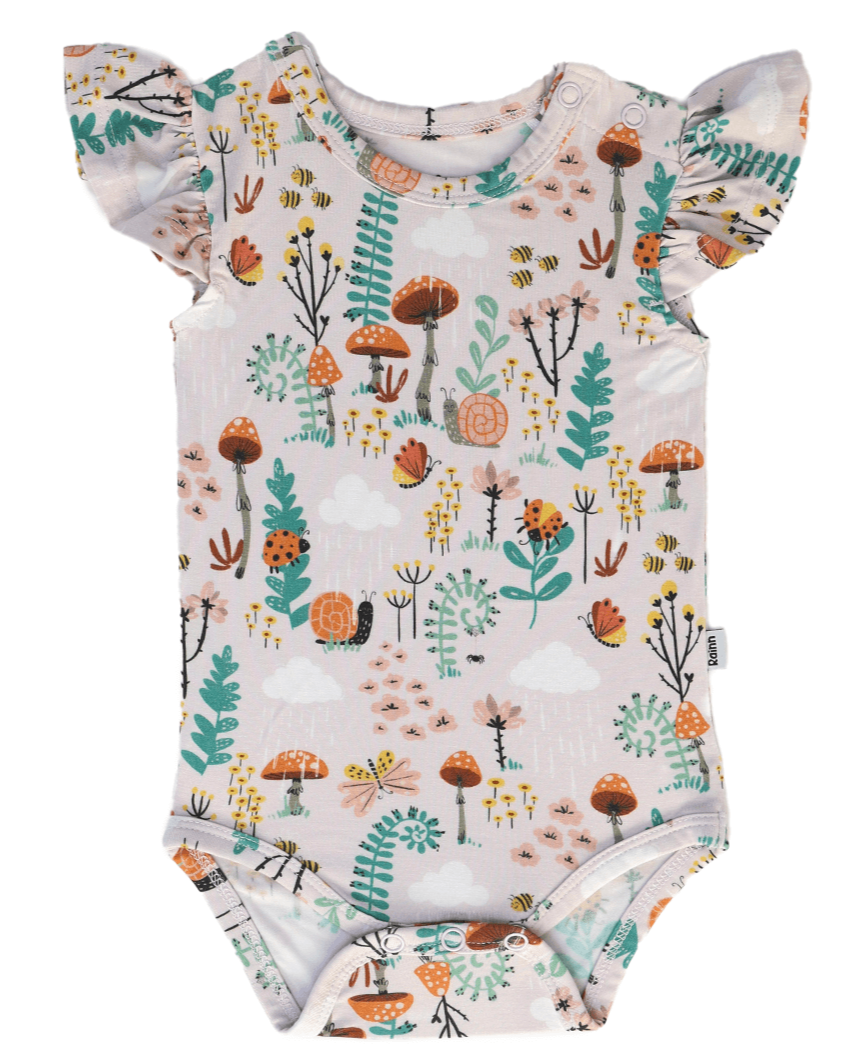 Bamboo Ruffle Onsie in fern design with ruffle sleeves featuring mushrooms, ferns, insects, and snails for a woodland-inspired look.