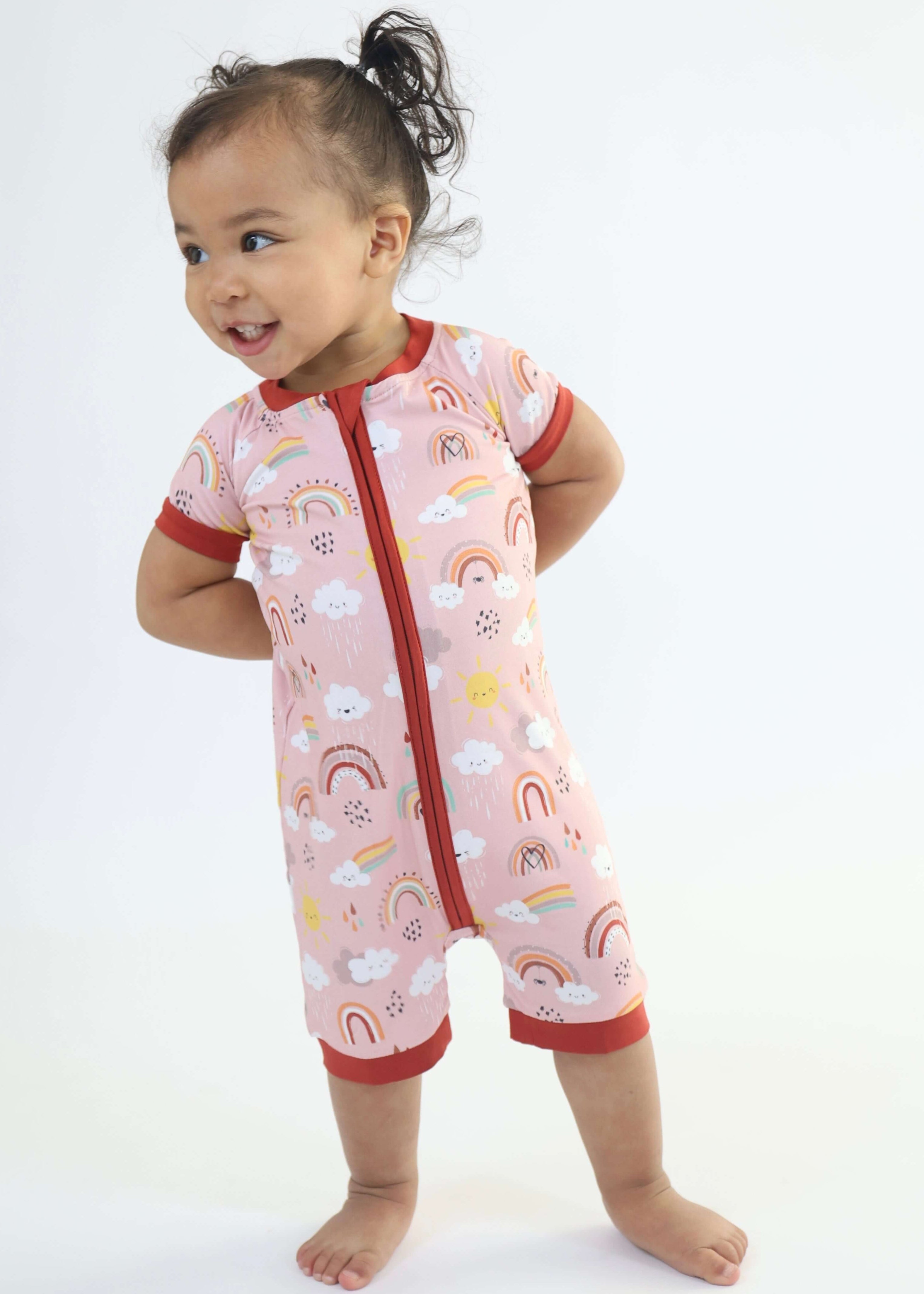 Toddler wearing Bamboo Short Romper with rainbow print, perfect for adventures