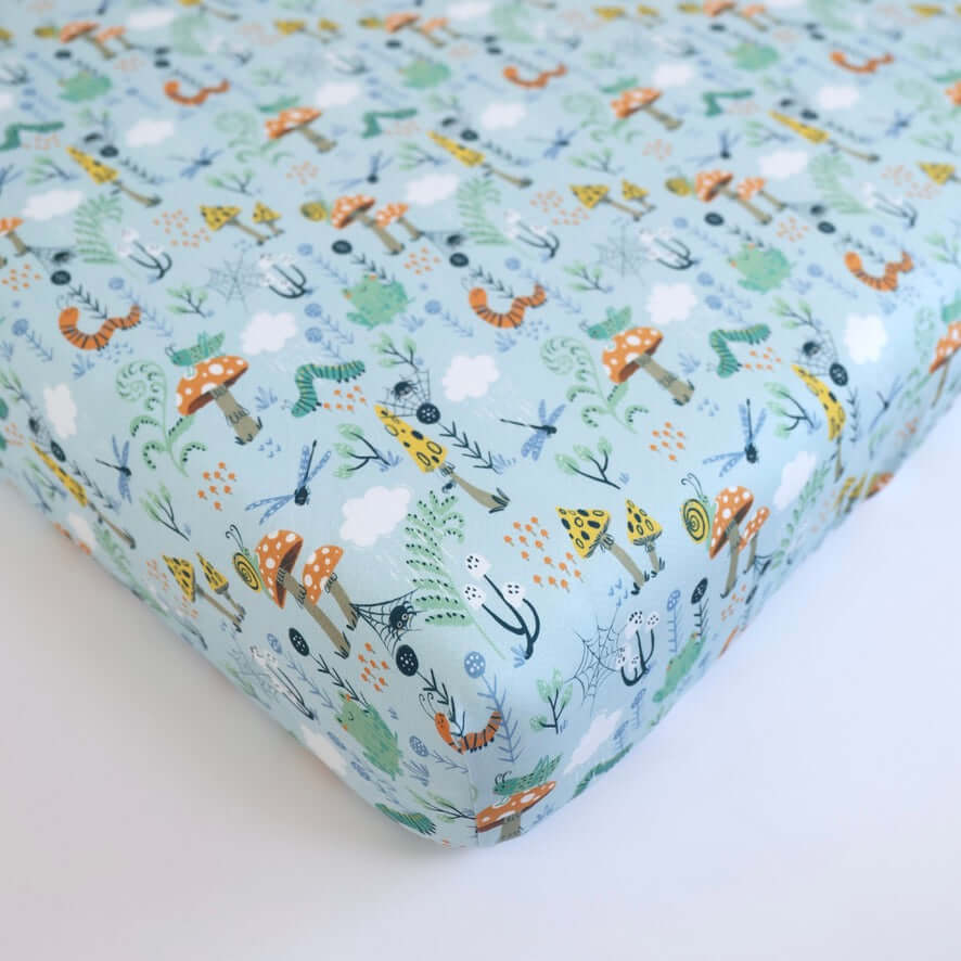 Colorful bamboo crib sheet featuring playful animal and nature patterns, perfect for baby's nursery.