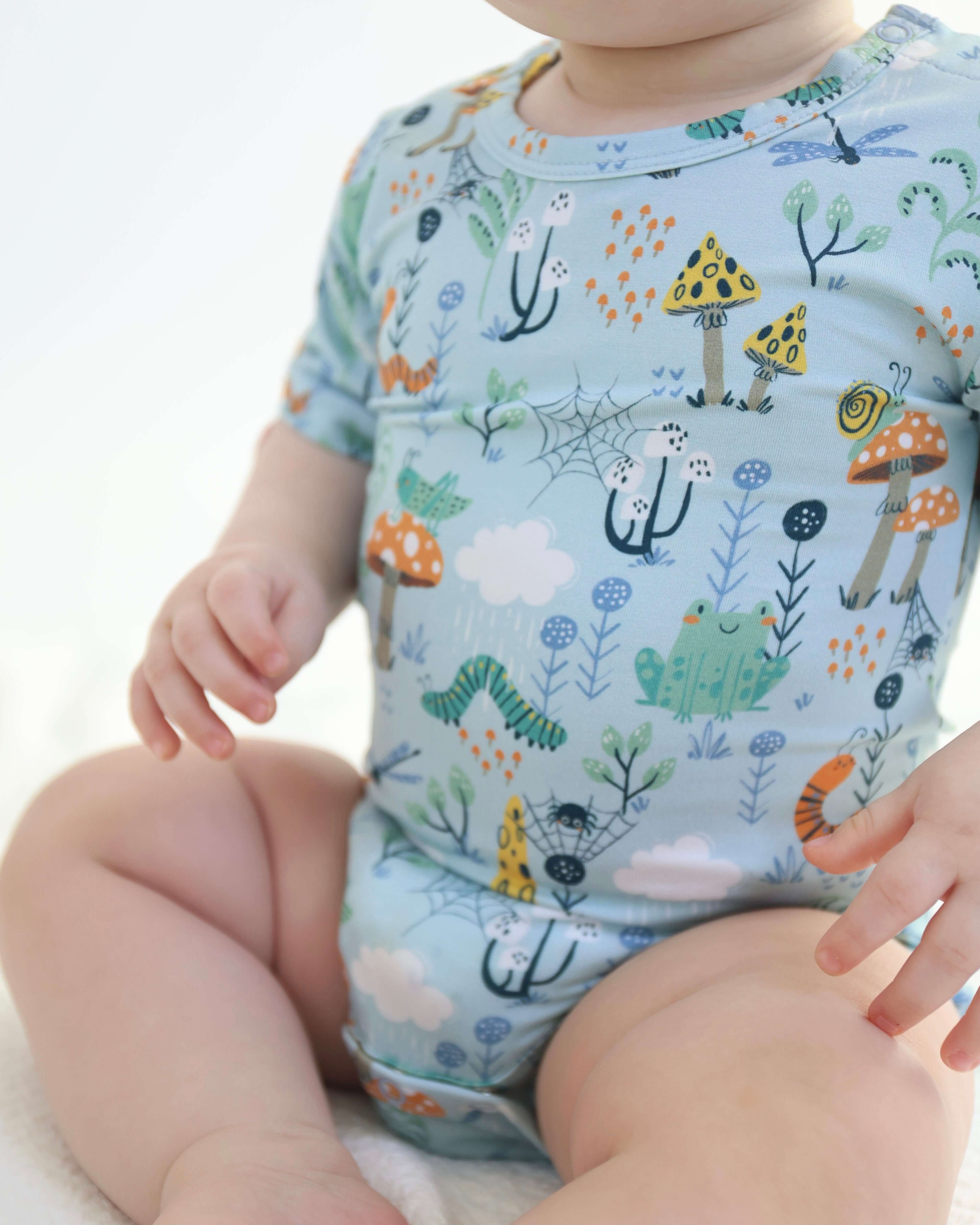 Bamboo onesie featuring colorful critters and nature patterns, perfect for comfy baby outfits.